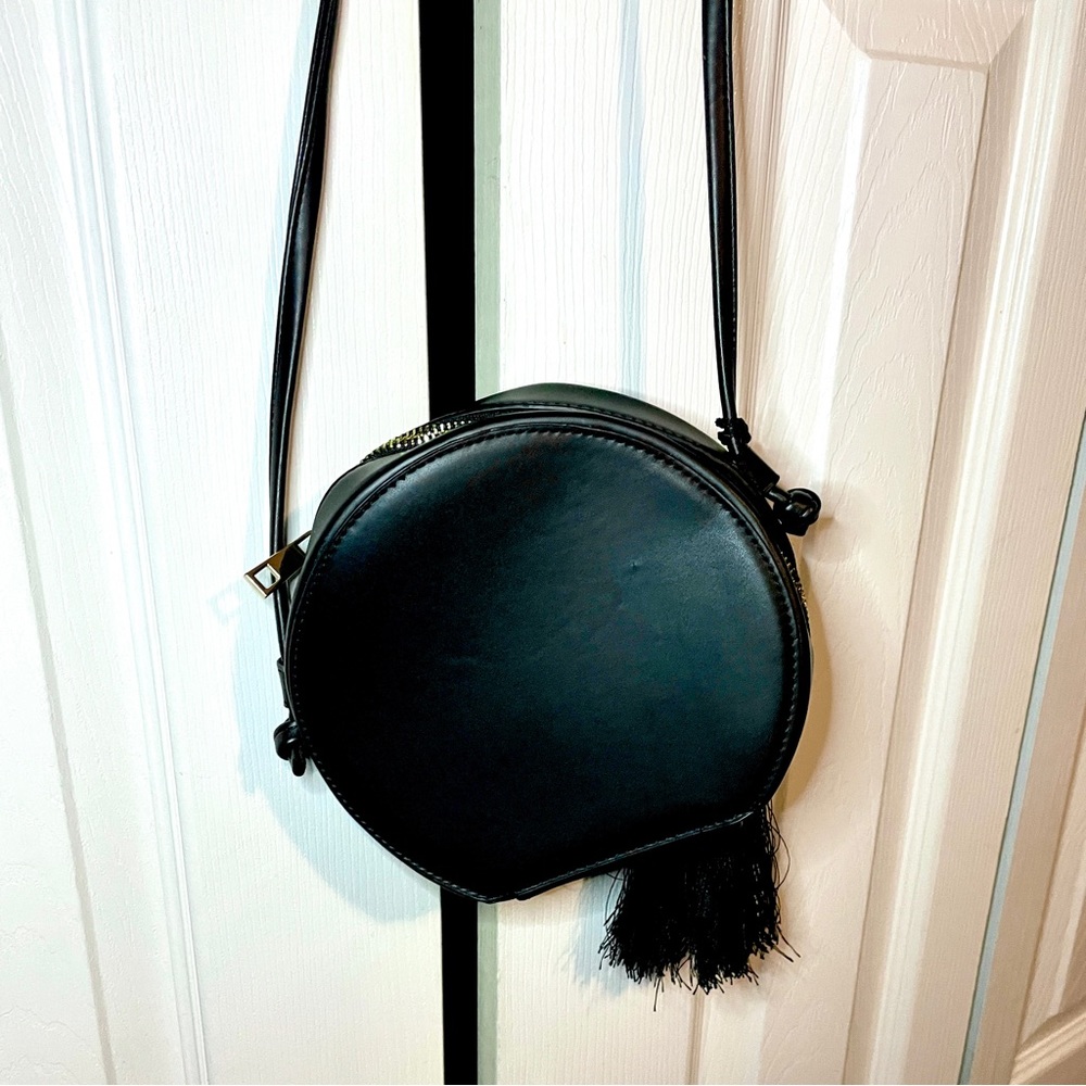 Black purse with tassel.